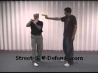 Self defense against high frontal gun attack.